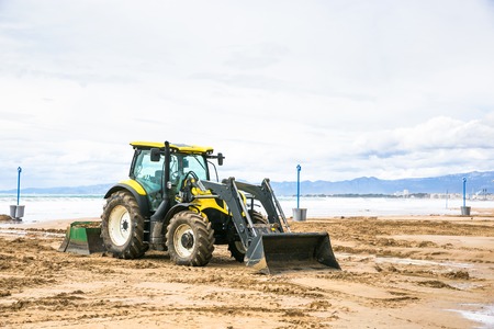 Tractor clean beach on coastline Costa Dorada, Salou, Spain.の写真素材