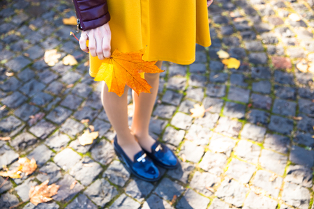 Happy teen girl with yellow leaf smile during walking on autumn park. Fall conceptの写真素材