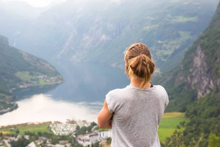 Happy sport woman hiking in Geirangerfjord. Norwayの写真素材