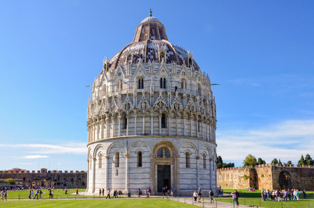 Tourists visit the Baptistery (Battistero) on the Square of Miracles (Campo dei Miracoli) in Pisa, Tuscany, Italy - 8 October 2011のeditorial素材