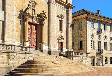 Little girl on the steps of the Church of St. Peter and St. Stephen (Chiesa Collegiata dei SS Pietro e Stefano) - Bellinzona, Switzerland, 16 July 2008のeditorial素材