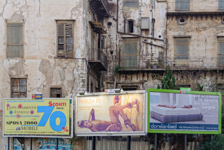 Illuminated billboards in front of a dilapidated house - Palermo, Sicily, Italy, 20 October 2011のeditorial素材