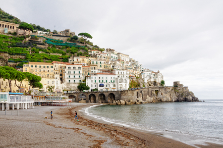 A couple has the whole beach to themselves on a stormy, overcast, autumn day - Amalfi, Campania, Italy, 27 October 2011のeditorial素材