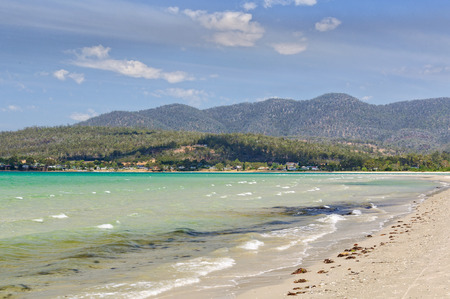 Low refracted swell and wind waves on the iconic Raspins Beach of Orford on the East Coast of Tasmania, Australiaの写真素材