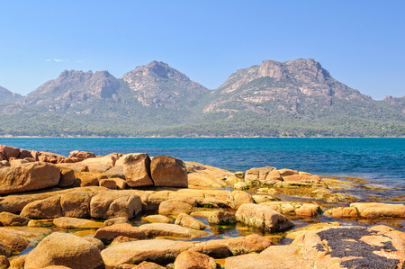 The Hazards mountain ranges in the Freycinet National Park photographed from Coles Bay - Tasmania, Australiaの写真素材