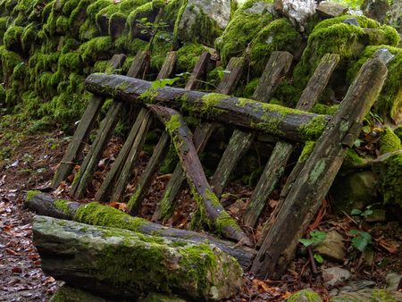 Old dry-stone wall and farm gate overgrown by moss - San Xil, Galicia, Spainの写真素材