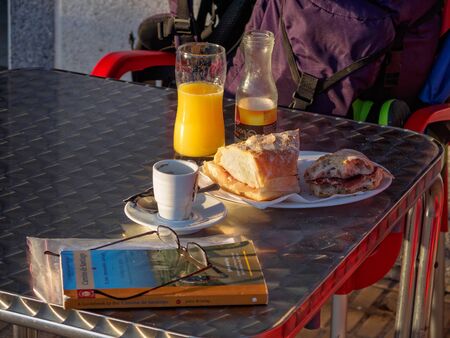 Well-deserved breakfast of a Camino pilgrim on a sunny autumn morning - Arca O Pino, Galicia, Spainのeditorial素材