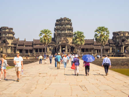 Tourists at the iconic West Gate of Angkor Wat - Siem Reap, Cambodiaのeditorial素材