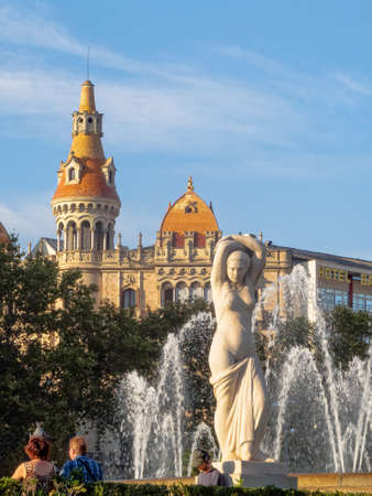 Sculpture Youth by Josep Clara (1928) and a water fountain on Plaza de Catalunya - Barcelona,...