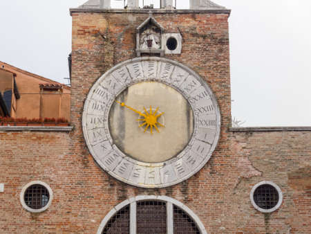 The 15th-century 24-hour clock above the entrance of San Giacomo di Rialto has only one hand - Venice, Veneto, Italyの写真素材