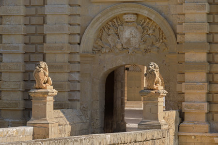 Stone lions hold the coat of arms of Vilhena at the Main Gate to the Silent City - Mdina, Maltaの写真素材