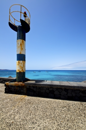 lighthouse and pier boat in the blue sky   arrecife teguise lanzarote spain
の写真素材