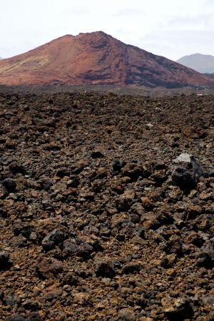 volcanic stone in los volcanes lanzarote  spain  timanfaya  rock  sky  hill and summer 
の写真素材