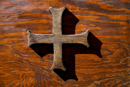 abstract cross   brass brown knocker in a   closed wood door  castiglione olona varese italyの写真素材