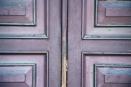 abstract samarate   rusty brass brown knocker in a  door curch  closed wood lombardy italy  varese