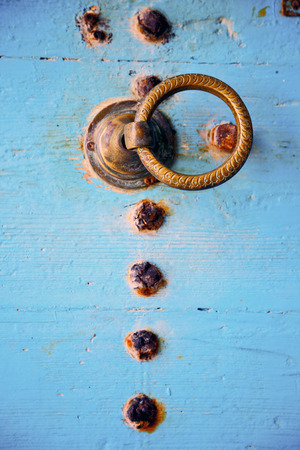 metal nail dirty stripped paint in the brown   red wood door and rusty  knockerの写真素材