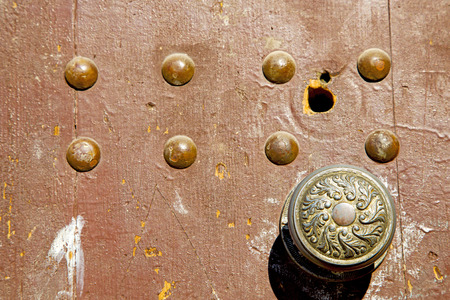 morocco knocker in africa the old wood  facade home and rusty safe padlockの写真素材