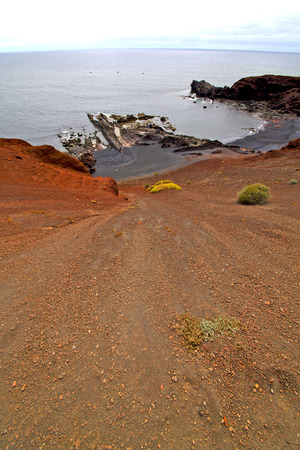 brown rock in white coast lanzarote   spain   beach  stone water  and summer herviderosの写真素材