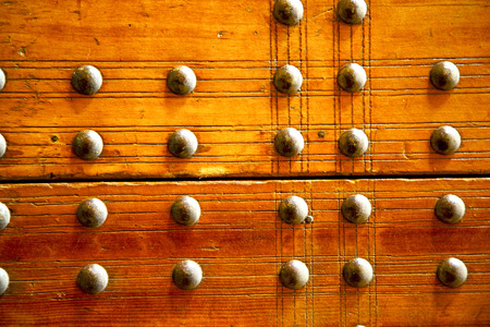 stripped paint in the blue  wood door and rusty   nailの写真素材