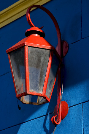 a red street lamp  and a blue yellow  wall in la boca buenos aires argentinaの写真素材
