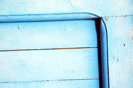 stripped paint in the blue wood door and rusty  nailの写真素材