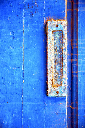 stripped paint in the blue wood door and rusty  nailの写真素材