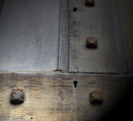 in london antique brown door  rusty  brass nail and light