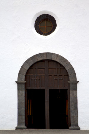 lanzarote  spain canarias brass brown knocker in a   closed wood  church door and white wall abstractの写真素材