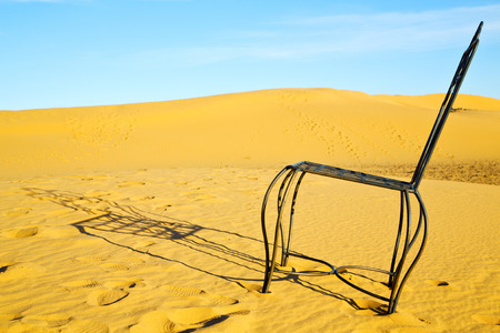 table and seat in  desert sahara morocco    africa yellow sandの写真素材