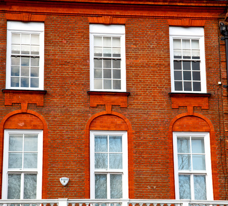 in europe london old red brick wall and      historical windowの写真素材