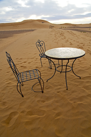 table and seat in  desert sahara morocco    africa yellow sandの写真素材