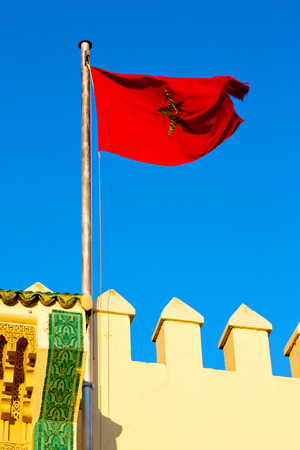 waving flag in the blue sky tunisia  colour and wave battlementsの写真素材