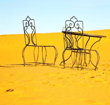 table and seat in  desert sahara morocco africa yellow sandの写真素材