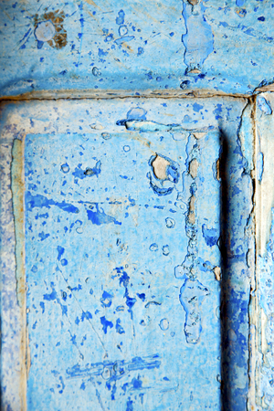 nail stripped paint in the blue wood door and rustyの写真素材