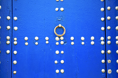 metal nail dirty stripped paint in the brown   red wood door and rusty  knockerの写真素材