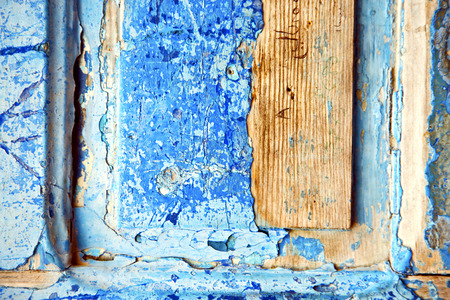 stripped paint in the blue wood door and rusty  nailの写真素材