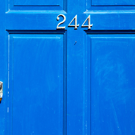 blue handle  in london antique  door  rusty  brass nail and lightの写真素材