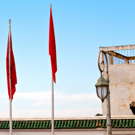 waving flag in the blue sky tunisia  colour and wave battlementsの写真素材
