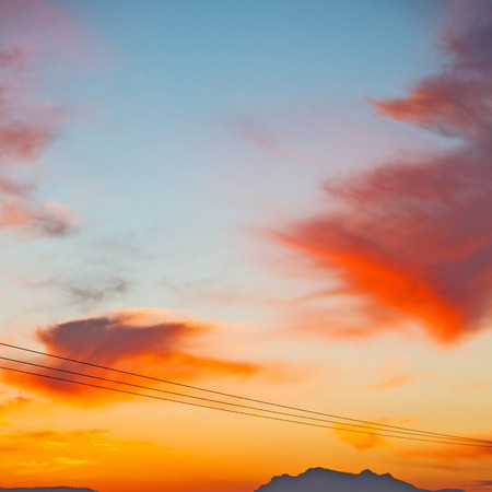 mountain in morocco africa and red sunrise current cables   power pylonの写真素材