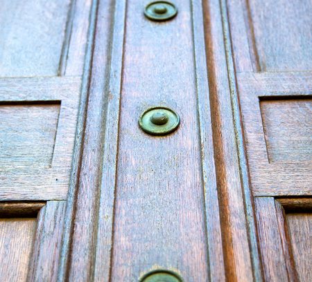 in london antique brown door  rusty  brass nail and light