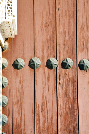 stripped paint in the blue  wood door and rusty   nailの写真素材