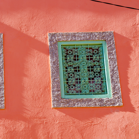 orange   window in morocco africa old construction and brown wall red carpetの写真素材