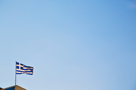 waving greece flag  in the blue sky and      flagpoleの写真素材