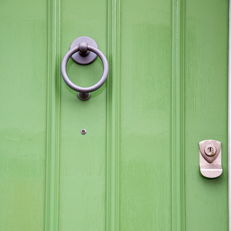 green  handle  in london antique  door  rusty  brass nail and lightの写真素材