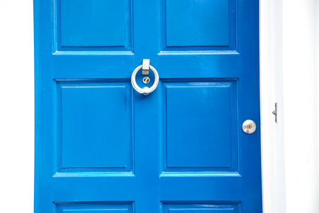 blue handle  in london antique  door  rusty  brass nail and lightの写真素材