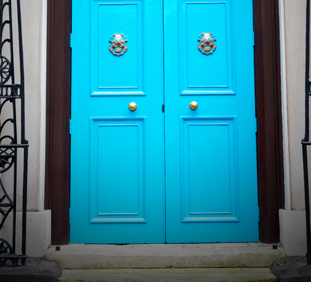 blue handle  in london antique  door  rusty  brass nail and lightの写真素材