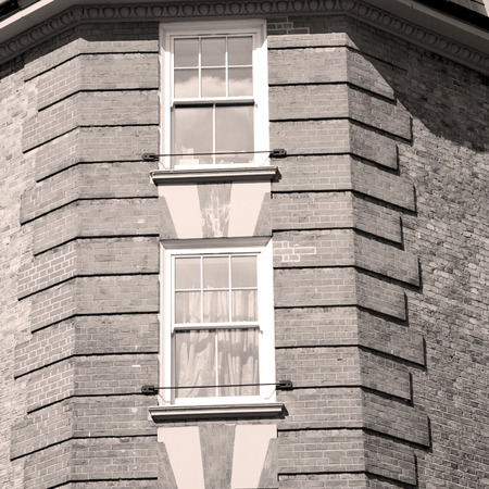 in europe london old red brick wall and          historical windowの写真素材