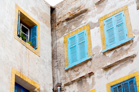 blue window in morocco africa old construction and brown wall  constructionの写真素材