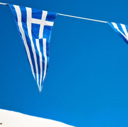 waving greece flag  in the blue sky and      flagpoleの写真素材