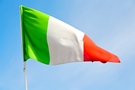 waving flag in the blue sky italy   colour and waveの写真素材